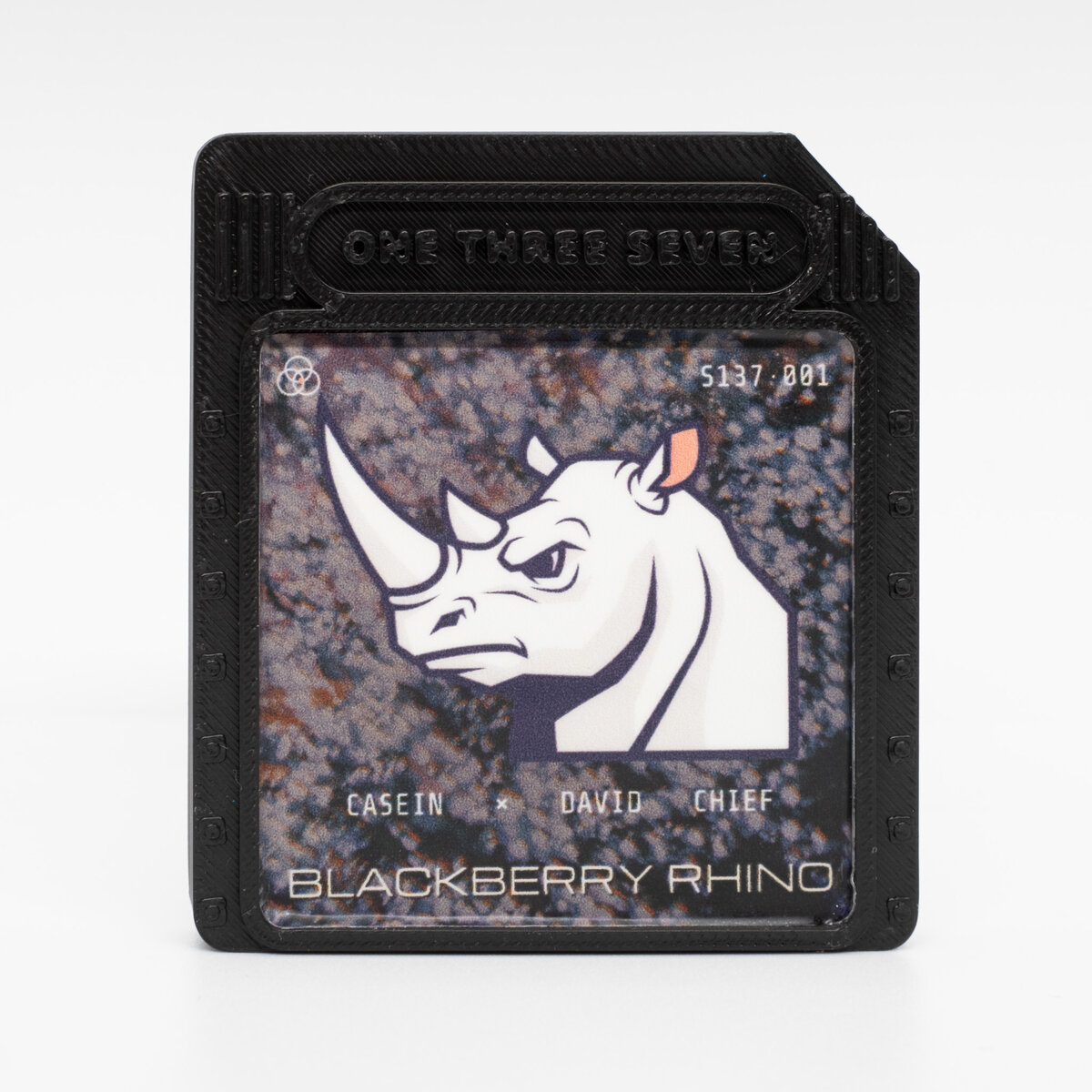 Blackberry Rhino NFC game cart — front, rhino badge sticker on the black shell, S137·001